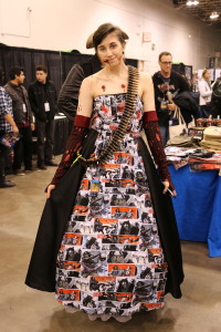 A cosplayer with a beautiful dress made out of pages from The Walking Dead comic book