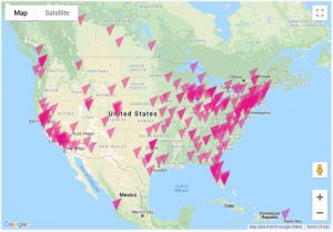 A map of North America with LGBT center locations marked by dozens and dozens of bright pink triangles. Most are on the coasts and upper midwest, but almost every state has at least one.
