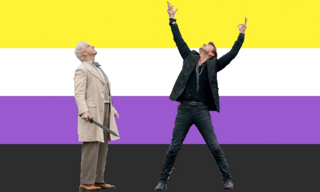  Crowley and Aziraphale from Good Omens have been photoshopped in front of a non-binary flag. Crowley is dramatically raising his arms in the air, and Aziraphale is looking up, slightly more calmly.