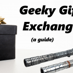 A black gift box with a gold bow sits next to two lightsabers. Text reads: Geeky Gift Exchange (a guide)