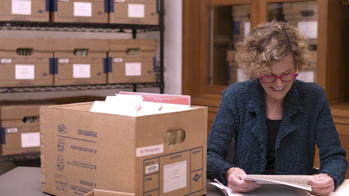 Judy Blume looking through fan letters in the Yale Library's archives.