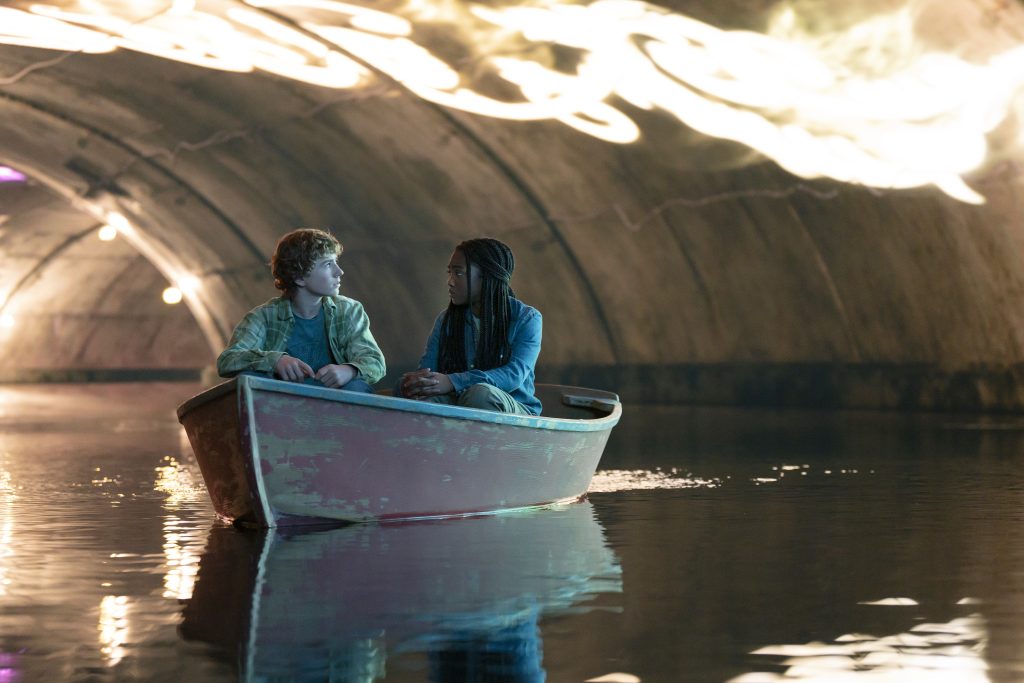 Percy Jackson (Walker Scobell) and Annabeth Chase (Leah Sava Jeffries) in a boat. 
