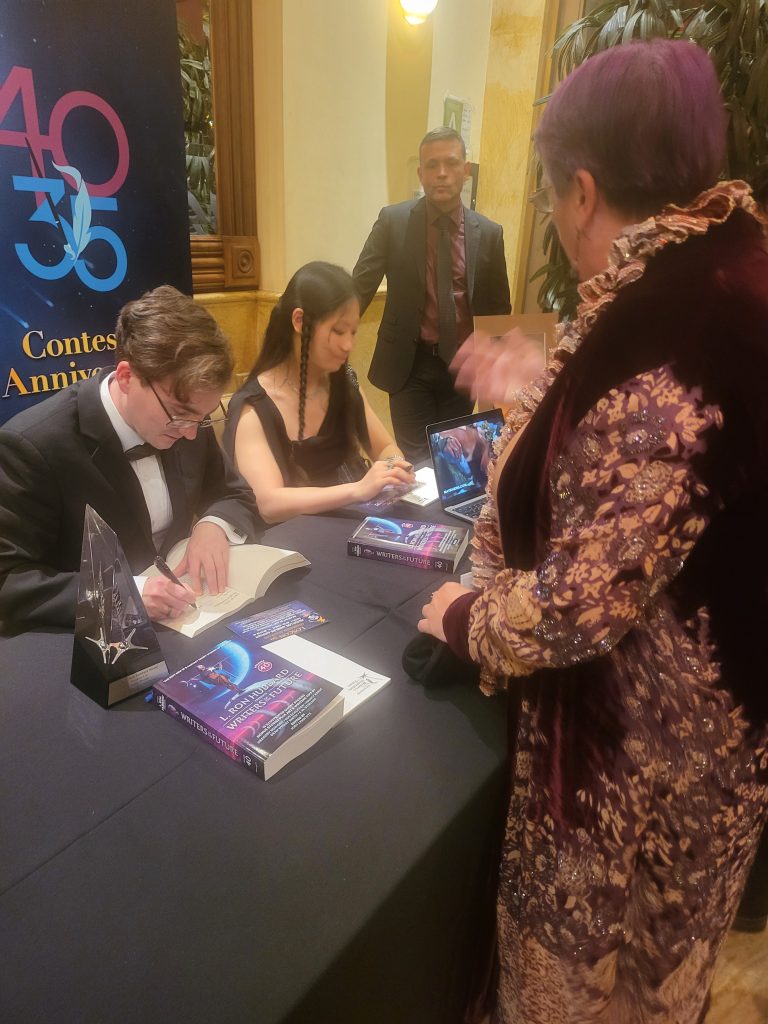 one of the contestants autographing the book