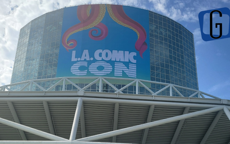 The outside of the Los Angeles Convention Center - a tower of glass windows - with a banner for LA Comic Con with tentacles coming down it.