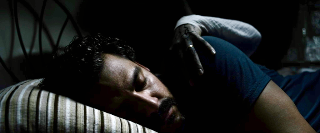 Kenneth Trujillo (as Richard) asleep as a grim hand grabs him.