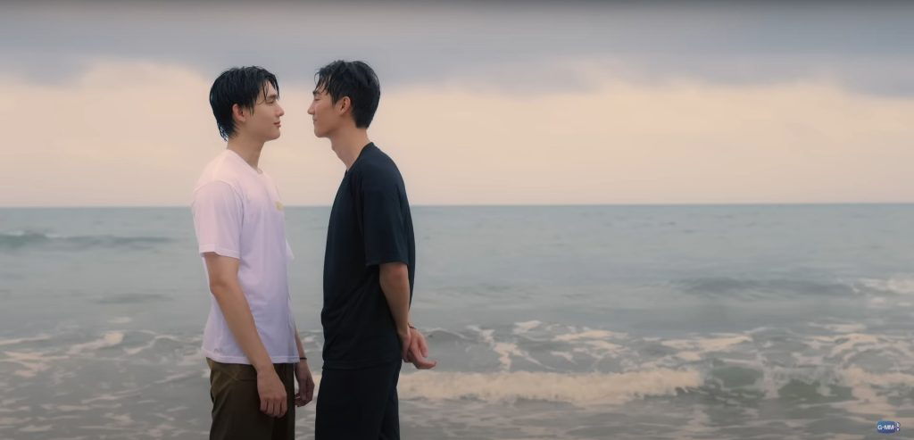 Arc and Arm stand very close together, facing each other. They are on the beach and both are wet from having been in the ocean. Arc has just kissed Arm on the forehead and they are smiling softly at each other.