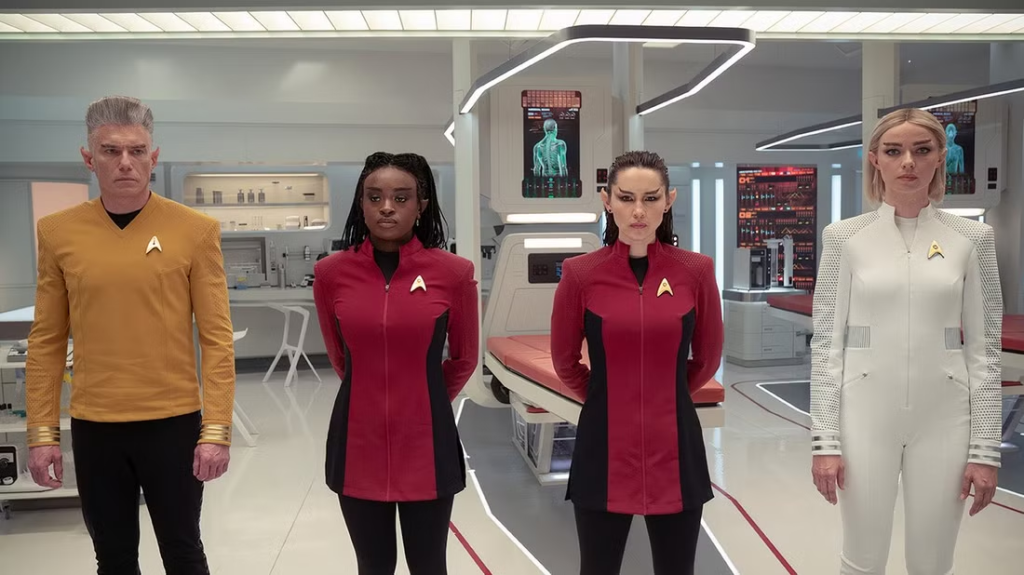 The heroes of Star Trek: Strange New Worlds stand in medbay with modifications that make them look Vulcan. Image courtesy of Paramount/CBS.