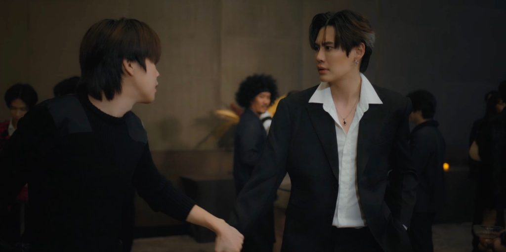 In the middle of a crowded ballroom, Punn grabs Ramil's hand and tries to pull him out of the room.