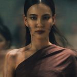 Still from Khemjira: a ghostly woman has come to claim Khem. She is wearing a toga-like garment. There are black lines along her skin. Other ghostly women are behind her.