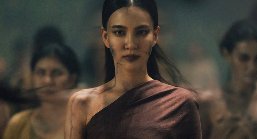 Still from Khemjira: a ghostly woman has come to claim Khem. She is wearing a toga-like garment. There are black lines along her skin. Other ghostly women are behind her.