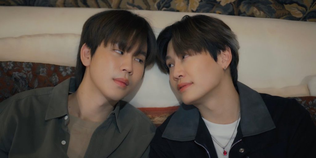 Ramil and Punn lean back against the sofa with their heads angled towards each other.