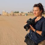 Lyndsey Addario, a war correspondent, stands in the sands of Afaganistan.