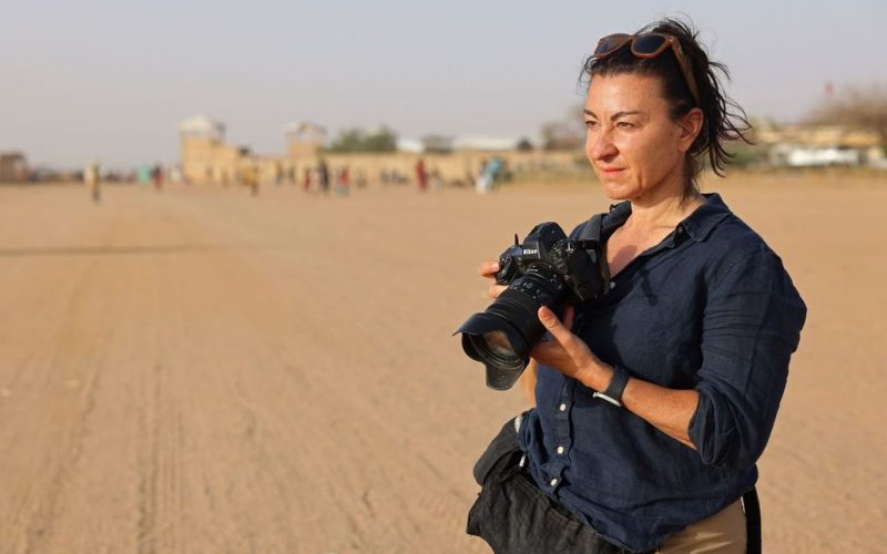 Lyndsey Addario, a war correspondent, stands in the sands of Afaganistan.