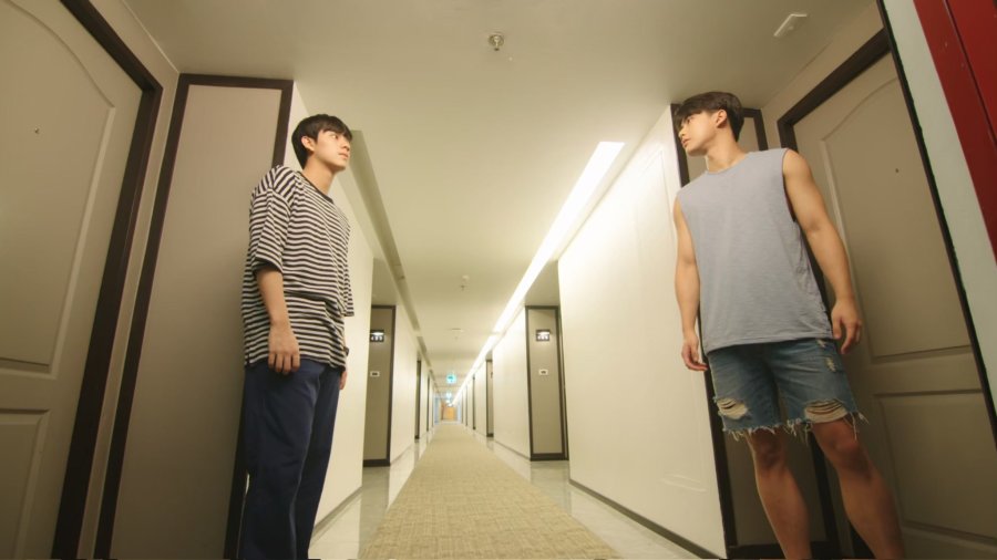 Pran and Pat face off against each other from their respective doors, across the hallway from each other.