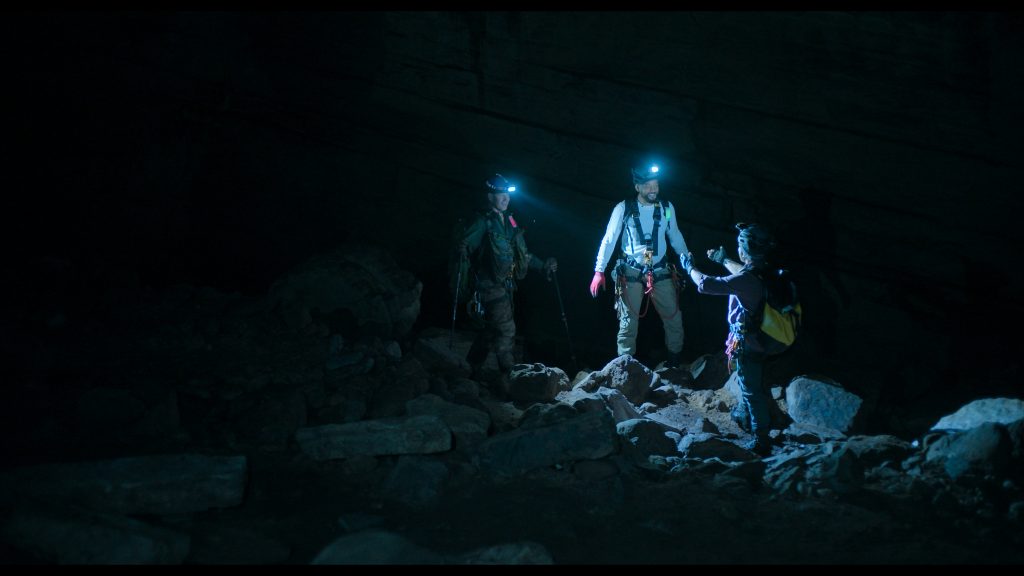 Scientist Bryan Fry, Will Smith and Carla Perez walk through the cave as they hunt down new critters.