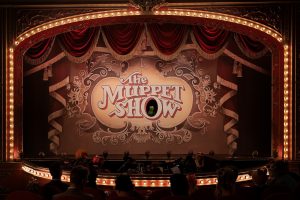 A theatre marquee with The Muppet Show on a screen in the middle.. Kermit is in the O. Photo by Mitch Haaseth and used courtesy Disney+.