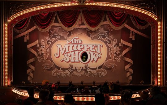 A theatre marquee with The Muppet Show on a screen in the middle.. Kermit is in the O. Photo by Mitch Haaseth and used courtesy Disney+.