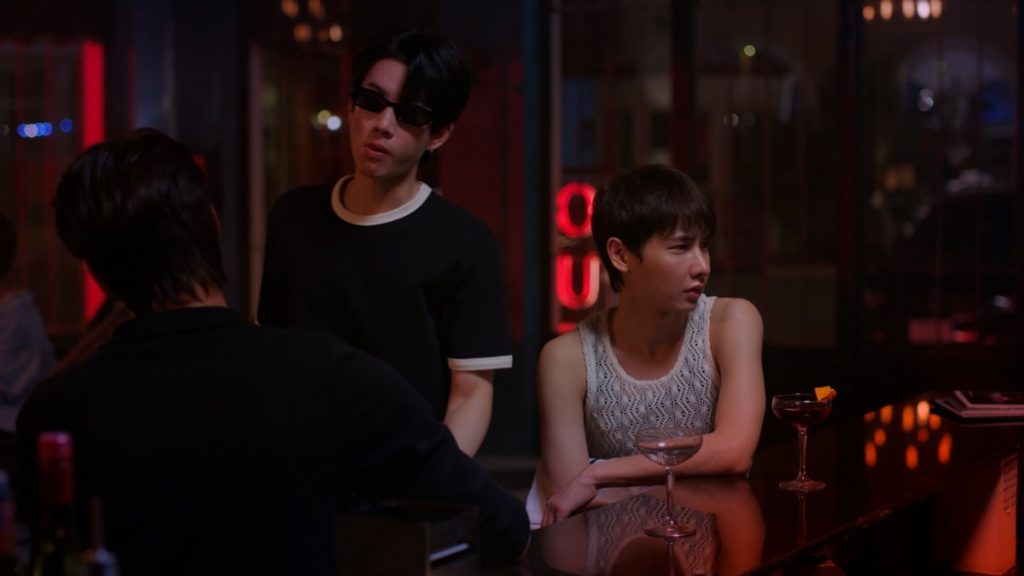 Koh confronts Jira and Pheem at Burnout Bar. Jira has turned away in disgust after Koh drank Pheem's wine.