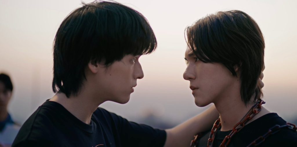 Niran and Pete stand very close together on the rooftop where they are performing the sealing ritual. Pete is in chains, as the bait for Qi Rong. Niran is gripping the back of Pete's head, looking intensely into his eyes, to reassure him that he'll be all right. And you cannot tell this in the photo but it's important to know that they are wearing matching shirts.